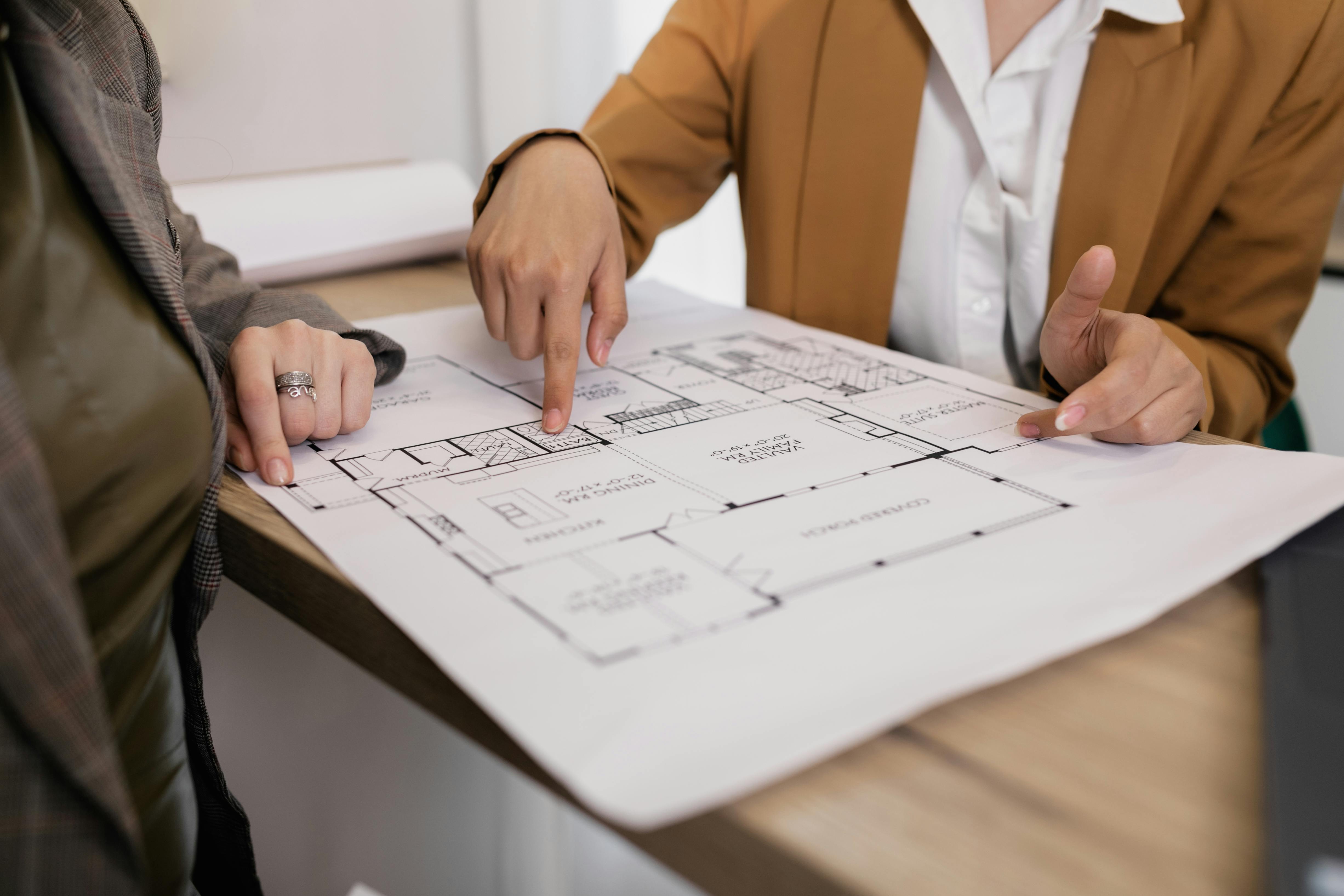 An image  of two people leaning over a planning document