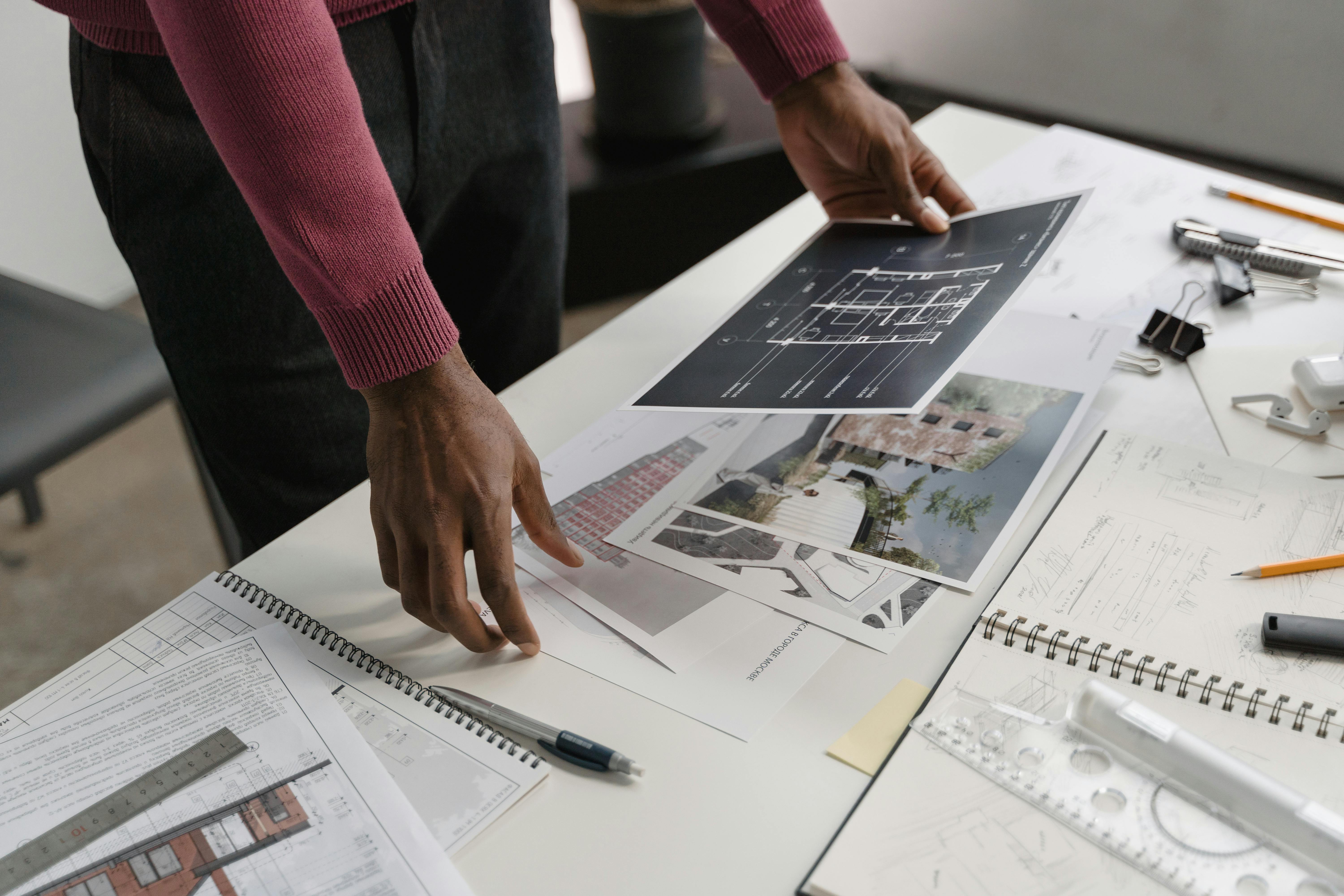 Person looking at blueprints and construction drawings on table